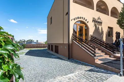 a building with a door and stairs on the side at Wine Pension Prague in Prague