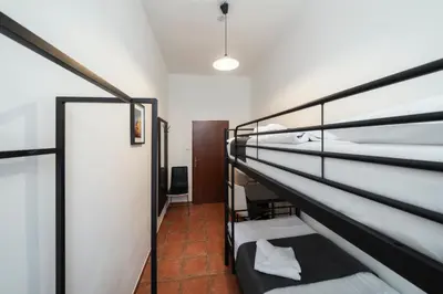 a room with two bunk beds and a corridor at Pension 15 Homér in Prague