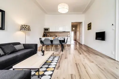 a living room with a couch and a table at Charles Bridge - 3 bedroom Apartment - Old Town in Prague