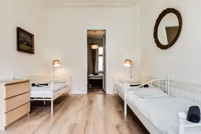 a bedroom with two beds and a mirror at Charles Bridge - 3 bedroom Apartment - Old Town in Prague