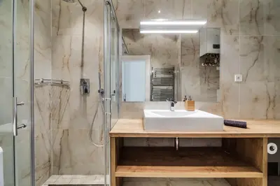 a bathroom with a sink and a shower at Charles Bridge - 3 bedroom Apartment - Old Town in Prague