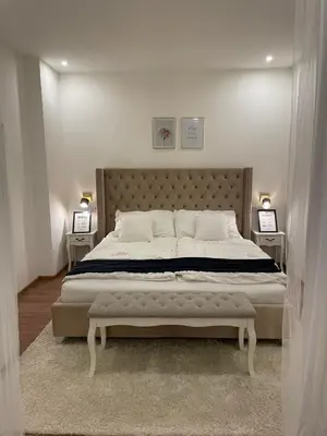 a bedroom with a large bed with two night stands at Nice and cozy apartment right at TV tower in Prague