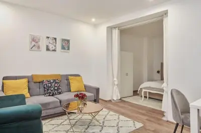 a living room with a couch and a table at Nice and cozy apartment right at TV tower in Prague