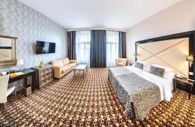 a hotel room with a large bed and a television at Grandior Hotel Prague in Prague