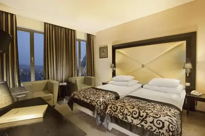 a hotel room with a large bed and a desk at Grandior Hotel Prague in Prague