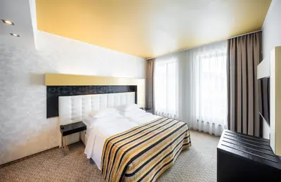 a hotel room with a bed and a large window at Grandior Hotel Prague in Prague