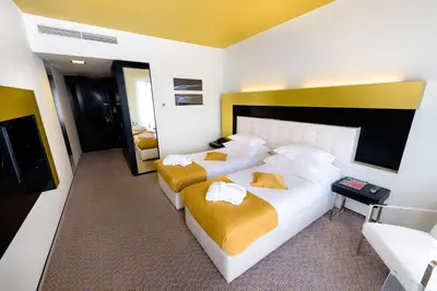 a hotel room with two beds and a television at Grandior Hotel Prague in Prague