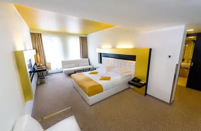 a large hotel room with a bed and a couch at Grandior Hotel Prague in Prague