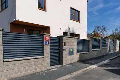 a row of gates on the side of a building at Home Le Fame in Prague