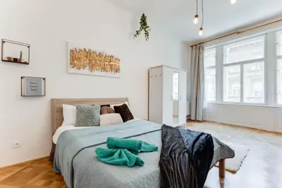a bedroom with a large bed with green towels on it at Spacious cozy 2bds apt in center - stp4 in Prague