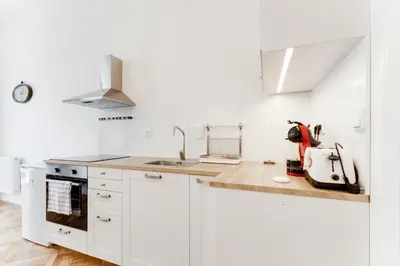 a white kitchen with white cabinets and a sink at Spacious cozy 2bds apt in center - stp4 in Prague