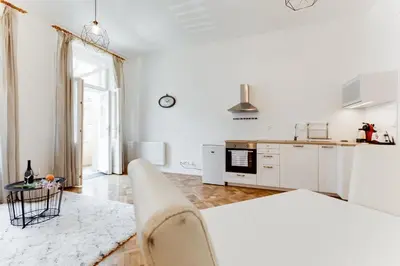 a white apartment with a kitchen and a living room at Spacious cozy 2bds apt in center - stp4 in Prague