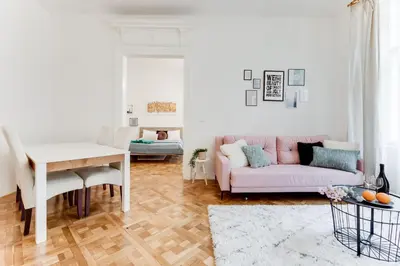 a living room with a pink couch and a table at Spacious cozy 2bds apt in center - stp4 in Prague