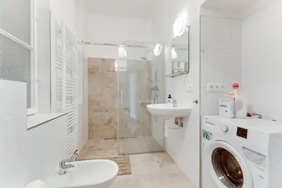a bathroom with a washing machine and a sink at Spacious cozy 2bds apt in center - stp4 in Prague