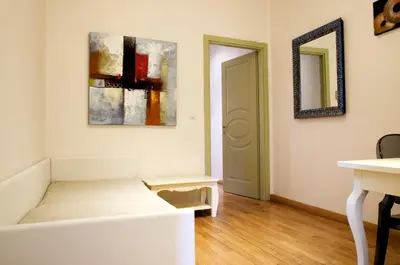 a room with a bed and a mirror on the wall at Dolce Vita Suites Boutique in Prague