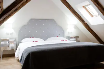 a bedroom with a large bed with a blue headboard at Dolce Vita Suites Boutique in Prague