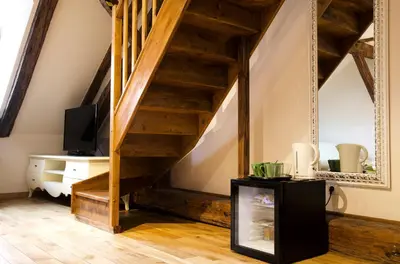 a living room with a staircase and a tv at Dolce Vita Suites Boutique in Prague
