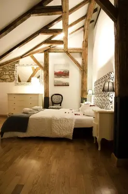 a bedroom with a large bed and a desk at Dolce Vita Suites Boutique in Prague