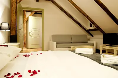 a bedroom with a bed with red rose petals on it at Dolce Vita Suites Boutique in Prague