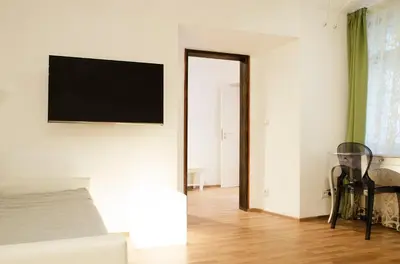 a living room with a television on a wall at Dolce Vita Suites Boutique in Prague