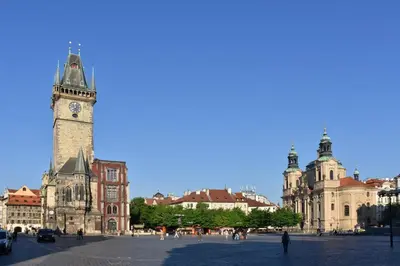 a building with a clock tower in a city at Get Prague Flat Stepanska in Prague