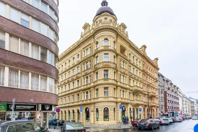 a large yellow building on a city street at Get Prague Flat Stepanska in Prague