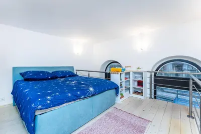 a bedroom with a bed and a balcony at Get Prague Flat Stepanska in Prague