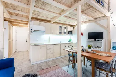 a kitchen and dining room with a table and chairs at Get Prague Flat Stepanska in Prague