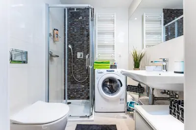 a bathroom with a washing machine and a washer and dryer at Get Prague Flat Stepanska in Prague