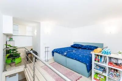 a bedroom with a bed with a blue comforter at Get Prague Flat Stepanska in Prague