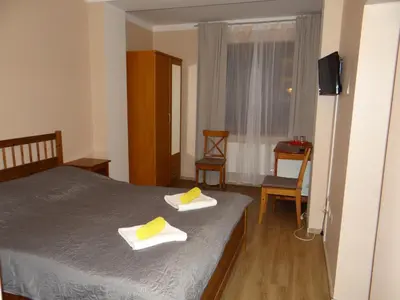 a bedroom with a bed with two towels on it at Pension Europa in Prague