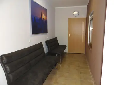 a living room with two leather couches and a door at Pension Europa in Prague
