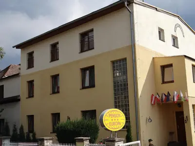 a building with a yellow sign in front of it at Pension Europa in Prague