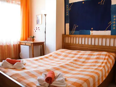 a bedroom with a bed with towels on it at Pension Europa in Prague