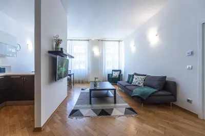 a living room with a couch and a table at Wishlist Old Prague Residences - Haštalská in Prague