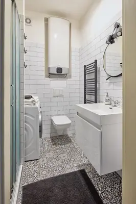 a white bathroom with a sink and a toilet at Prague Days - One-bedroom Apartment with View of Castle from Balcony near Wenceslas Square in Prague