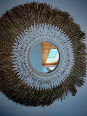 a circular mirror with a reflection of a building at apartmán Sázava in Sázava