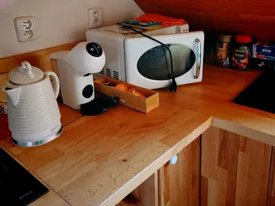 a microwave sitting on top of a wooden counter at apartmán Sázava in Sázava