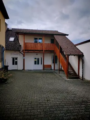 a house with a wooden deck and a balcony at apartmán Sázava in Sázava