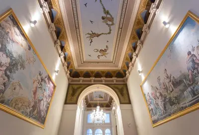 an ornate hallway with paintings on the ceilings at TurnKey I Downtown Studio in Prague