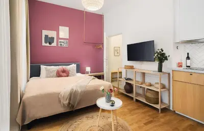 a bedroom with a bed and a purple wall at TurnKey I Downtown Studio in Prague