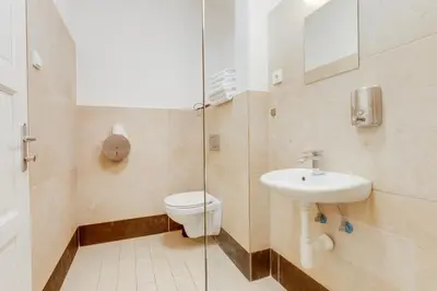 a bathroom with a toilet and a sink at Riben House Prague in Prague