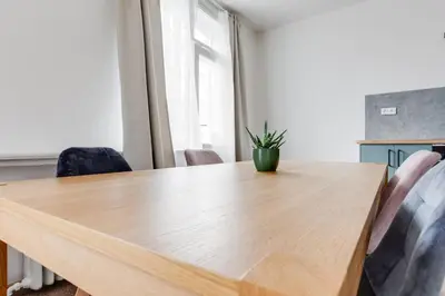 a dining room table with a potted plant on it at Riben House Prague in Prague