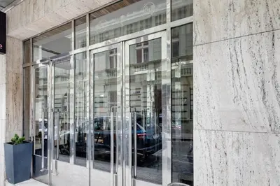 a glass window of a building with cars in it at Riben House Prague in Prague