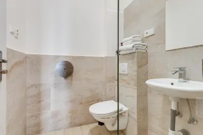 a bathroom with a toilet and a sink at Riben House Prague in Prague