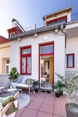 a house with a patio with a couch at TurnKey I Main Bus Station Apartments in Prague