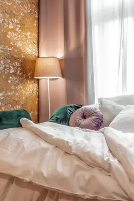 a bed with white sheets and pillows next to a window at TurnKey I Main Bus Station Apartments in Prague