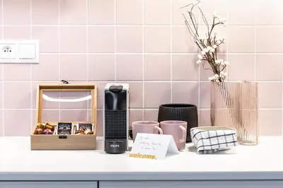a kitchen counter with a hair drier and a box of fruit at TurnKey I Main Bus Station Apartments in Prague