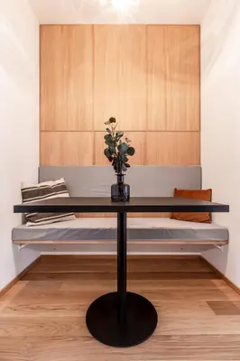 a table in front of a bed in a room at TurnKey I Main Bus Station Apartments in Prague