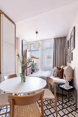 a living room with a table and a couch at TurnKey I Main Bus Station Apartments in Prague